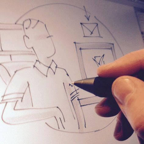 Photo du travail de storyboard à la tablette graphique. Détail d'un dessin de personnage qui reçoit un e-mail sur son ordinateur.
